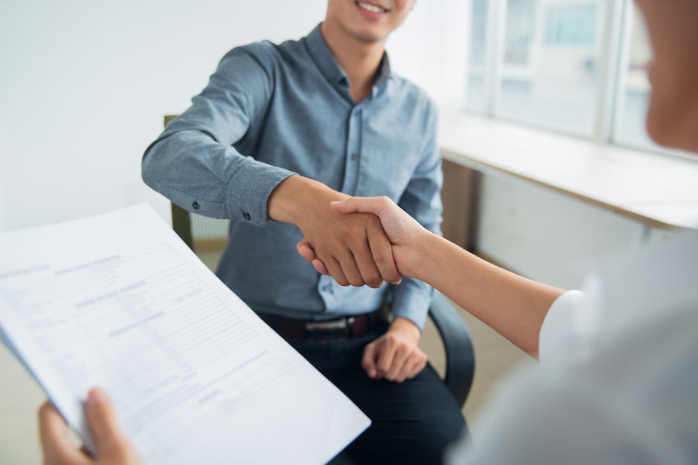smiling-asian-businessman-shaking-partners-hand